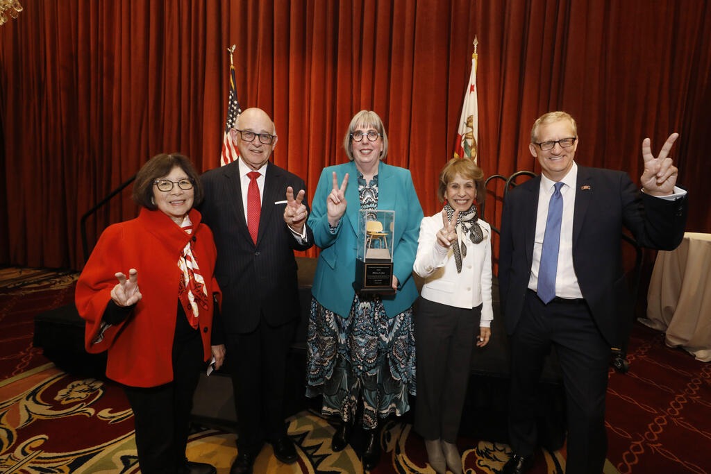 Dean Melissa Just (center) holds the Valerie and Ronald Sugar Dean's Chair of the USC Libraries with (left-to-right) Valerie Sugar, Ronald Sugar, President Carol Folt, and Provost Andrew T. Guzman